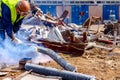 Worker is cutting scrap metal with acetylene torch