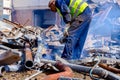 Worker is cutting scrap metal with acetylene torch