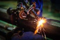 Worker cutting steel pipe with acetylene welding cutting torch a