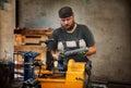 Worker cutting steel pipe with machine for threading