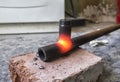 Worker cutting steel pipe using metal torch