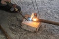 Worker cutting steel pipe using metal torch
