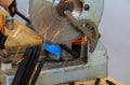 Worker in cutting a steel rail with circular electro saw