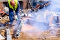 Worker is cutting scrap metal with acetylene torch