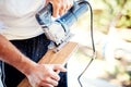 Worker cutting wood parquet using circular saw during home improvement works