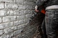 Worker with demolition hammer removing plaster from wall. Royalty Free Stock Photo