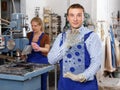 Worker demonstrating glass with bores