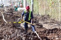 Worker digging a road trench