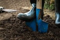 Worker digs the black soil with shovel in the vegetable garden Royalty Free Stock Photo