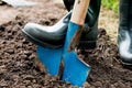 Worker digs the black soil with shovel in the vegetable garden Royalty Free Stock Photo