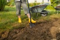 Worker digs the black soil with shovel in the vegetable garden, woman farmer loosens dirt in the farmland, agriculture Royalty Free Stock Photo