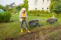 Worker digs the black soil with shovel in the vegetable garden, woman farmer loosens dirt in the farmland, agriculture Royalty Free Stock Photo