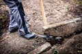 worker digs out a kerbstone with the help of a pickaxe Royalty Free Stock Photo