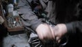 Worker is disassembling car engine in a repair shop, twisting bolts and detaching details with force