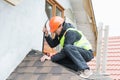 Worker dismantling roof shingles Royalty Free Stock Photo