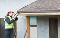 Worker dismantling roof shingles Royalty Free Stock Photo