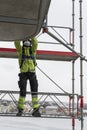 Worker dismantling temporary scaffolding wintertime Royalty Free Stock Photo