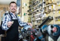 Worker displaying result of his key making in workplace Royalty Free Stock Photo