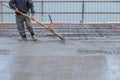 Worker disposes of the liquid concrete along the reinforcement Royalty Free Stock Photo