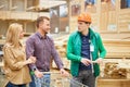 Worker of distribution center talk to couple in store