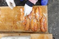 Worker does salting and drying grey mullet roe