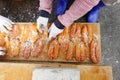 Worker does salting and drying grey mullet roe