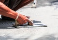 Worker does smooth the plasterer concrete