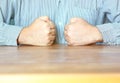 The worker doing double handful on table in front of his breast