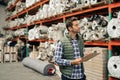 Worker doing an inventory check on a warehouse floor