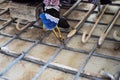 Worker doing steelwork for reinforcement of concrete floor at the construction site Royalty Free Stock Photo