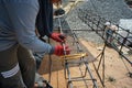 Worker doing the steelwork for reinforcement of the concrete structure.