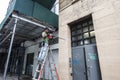 Worker with a drill making a hole in the wall in New York City, USA