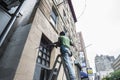 Worker with a drill making a hole in the wall in New York City, USA