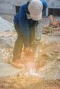 Worker drilling cement concrete floor with machine