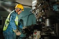 Worker Drilling machine hole metal flat steel plate and selective focus with bench drill in the factory