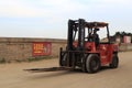 Worker drive red forklift