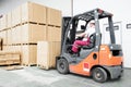 Worker driver at warehouse forklift