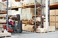 Worker driver at warehouse forklift loader works Royalty Free Stock Photo