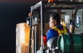 Worker driver at warehouse forklift loader works to containers box, worker man in warehouse with forklift Royalty Free Stock Photo