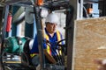 Worker driver at warehouse forklift loader works to containers box, worker man in warehouse with forklift Royalty Free Stock Photo