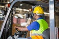 Worker driver at warehouse forklift loader works to containers box, worker man in warehouse with forklift Royalty Free Stock Photo