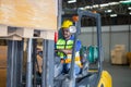 Worker driver at warehouse forklift loader works to containers box, worker man in warehouse with forklift Royalty Free Stock Photo