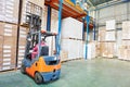 Worker driver at warehouse forklift loader works