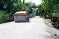 Worker drives the road roller on the crash stone road for preparaing the surface