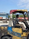 A worker is driving a forklift.