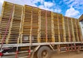 Worker driving forklift loading shipment carton boxes goods on wooden pallet at loading dock from container truck to warehouse car