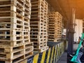 Worker driving forklift loading and unloading shipment carton boxes and goods on wooden pallet from container truck to warehouse c