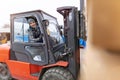 Worker driving forklift in lumber yard Royalty Free Stock Photo