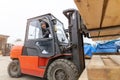 Worker driving forklift in lumber yard Royalty Free Stock Photo