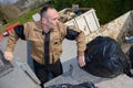 Worker dumping rubbish bags